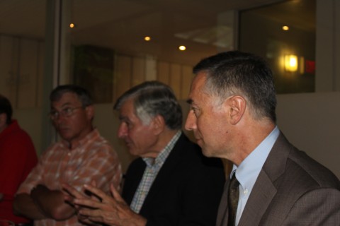 Professor Richard Locke (right) addresses the group as Governor Michael Dukakis (center) and Professor Thomas Kochan listen on.