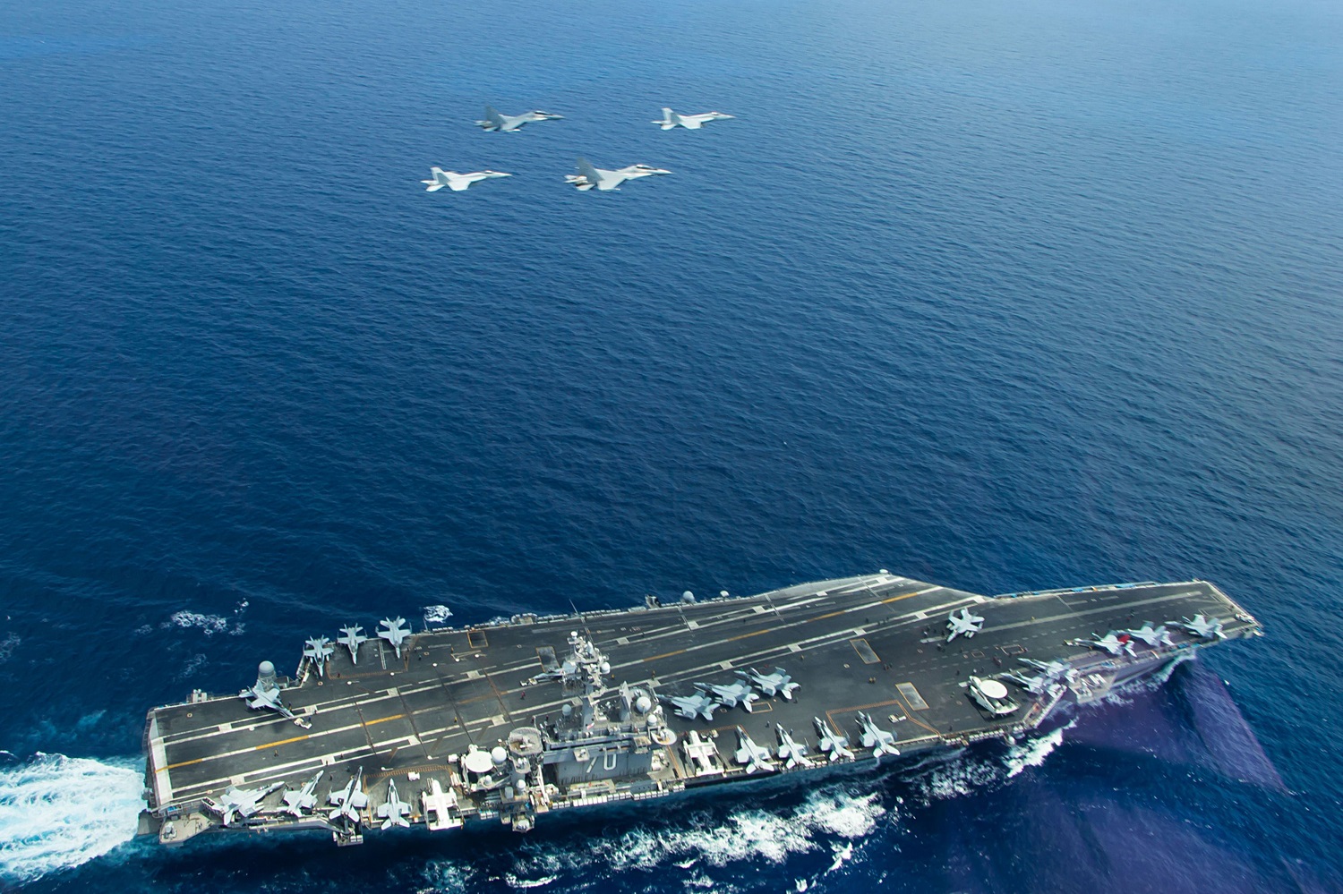 This May 10, 2015 US Navy handout photo shows two F/A-18 Super Hornets(L and R) and two Royal Malaysian Air Force SU-30MKM/Flanker H, flying above the aircraft carrier USS Carl Vinson (CVN 70) operating in the South China Sea during a bi-lateral exercise aimed at promoting interoperability with the Malaysian Royal Military. The Carl Vinson Strike Group is deployed to the U.S. 7th Fleet area of operations supporting security and stability in the Indo-Asia-Pacific region. AFP PHOTO / HANDOUT / US NAVY / LT. JONATHAN PFAFF == RESTRICTED TO EDITORIAL USE / MANDATORY CREDIT: "AFP PHOTO / HANDOUT / US NAVY / LT. JONATHAN PFAFF "/ NO MARKETING / NO ADVERTISING CAMPAIGNS / NO A LA CARTE SALES / DISTRIBUTED AS A SERVICE TO CLIENTS ==