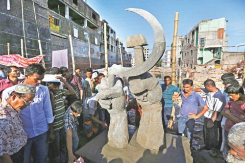 Activists and the relatives of missing garment workers gather on August 2 in front of a sculpture made by members of labour organisations at the site of collapsed Rana Plaza in Savar. Photo: REUTERS/FILE