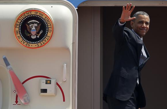 U.S. President Barack Obama waves from Air Force One as he departs Haneda International Airport in Tokyo