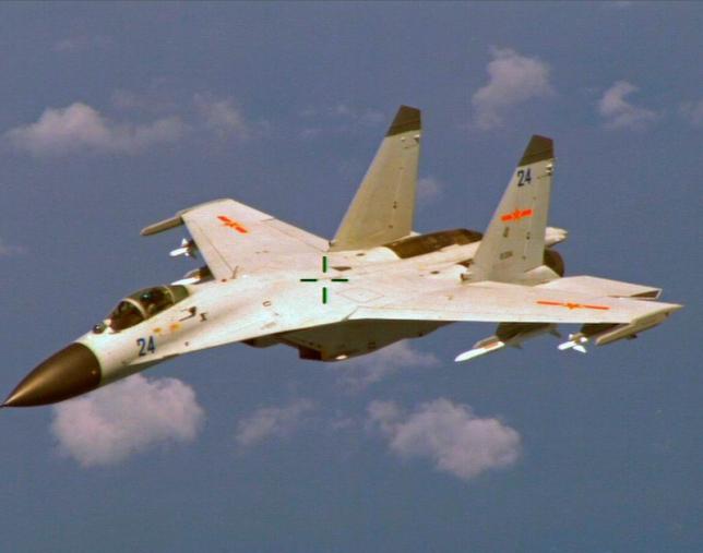File photo of a Chinese J-11 fighter jet seen flying near a U.S. Navy P-8 Poseidon about 215 km (135 miles) east of China's Hainan Island in this U.S. Department of Defense handout photo taken August 19, 2014. REUTERS/U.S. Navy/Handout