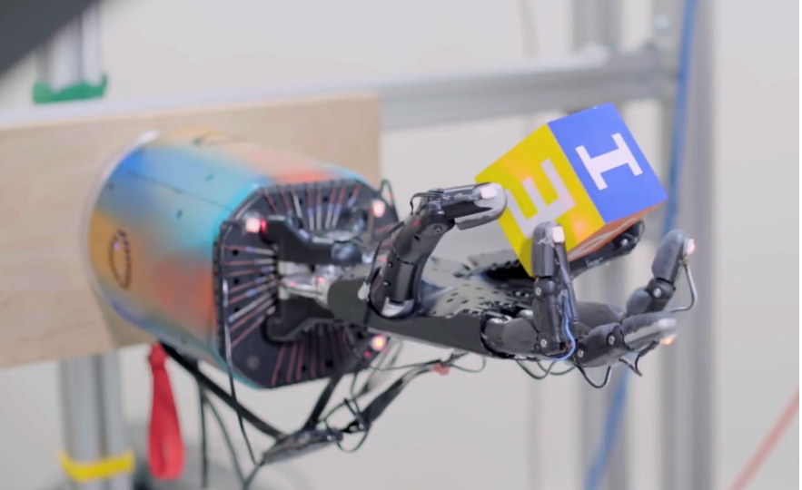 An AI robot hand teaches itself to rotate a cube by creating a virtual-reality environment