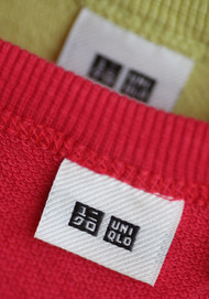 A tag with Fast Retailing Co.'s Uniqlo logo is displayed on a sweater at the company's store in the Ginza district of Tokyo. Credit- Bloomberg