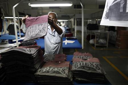 An employee sorts newly finished T-shirts at the Estee garment factory in Tirupur in Tamil Nadu June 19, 2013.  REUTERS/Mansi Thapliyal/Files